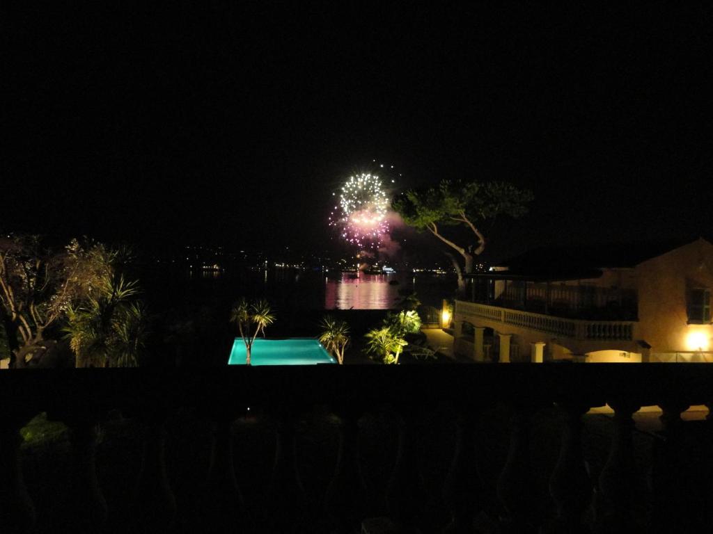 a firework display in the sky over a pool at night at Villa Playa del Sol -B4 in Saint-Tropez