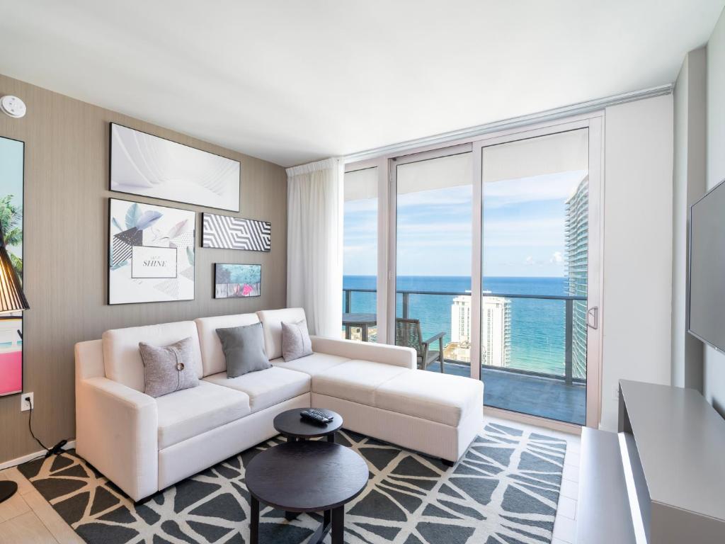 a living room with a white couch and large windows at Modern Waterfront Retreat with Scenic Views in Hollywood