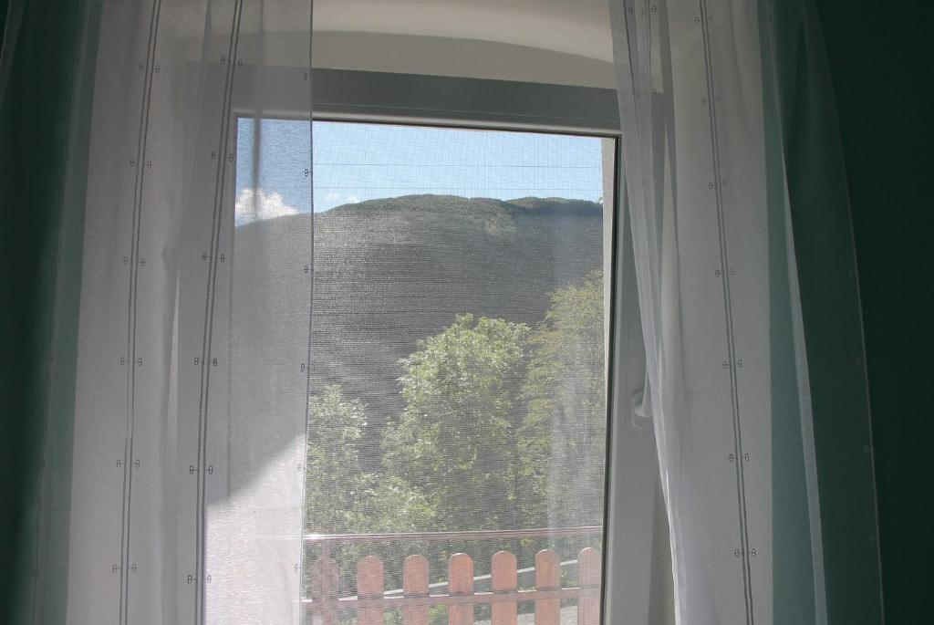 a window with a view of a mountain at Mike's Rooms in Kobarid