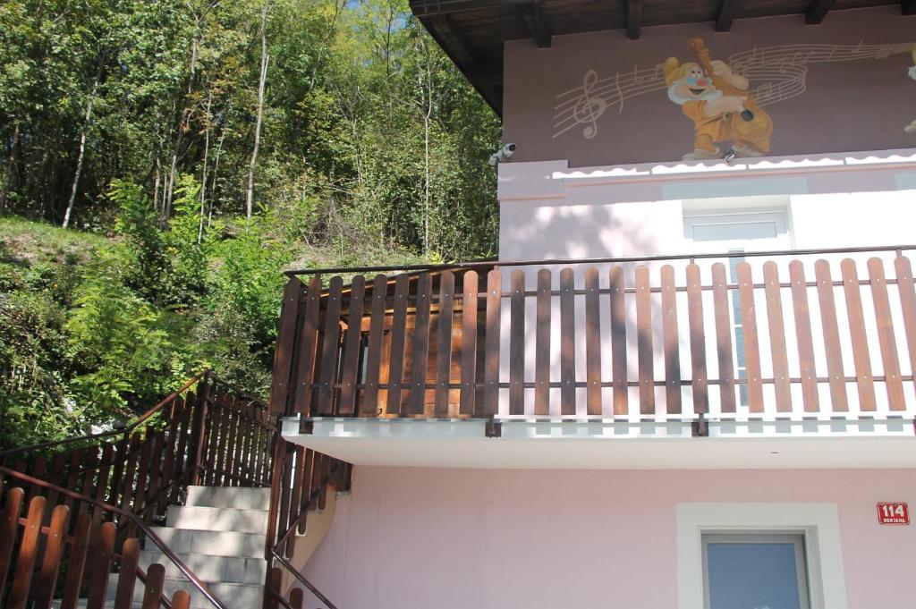 a mural on the side of a building with a balcony at Mike's Rooms in Kobarid
