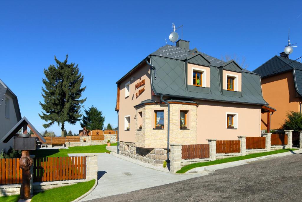 a large house with a black roof at Pension H.Blatná in Horní Blatná