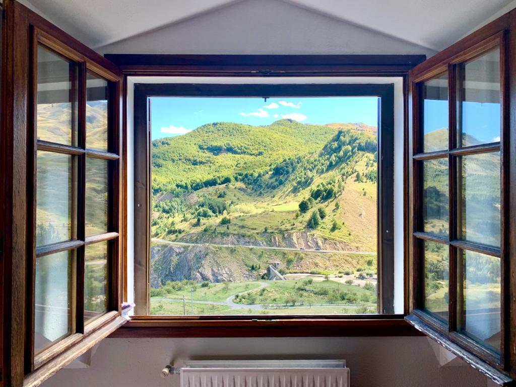 a window with a view of a mountain at Apartamentos Formigal - admite mascotas in Formigal