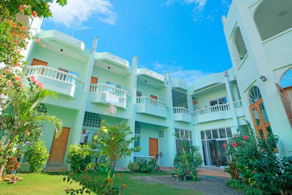 an exterior view of a large white building at Shorebreak Boracay Resort in Boracay