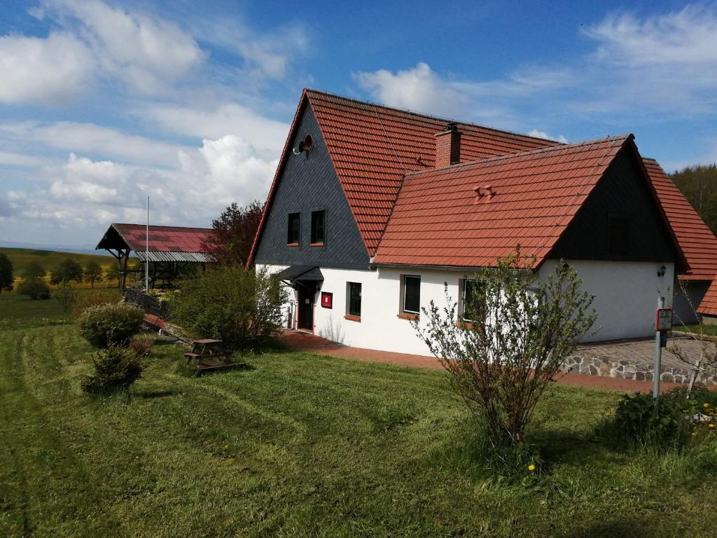 a black and white house with a red roof at Ober der Eller in Brotterode