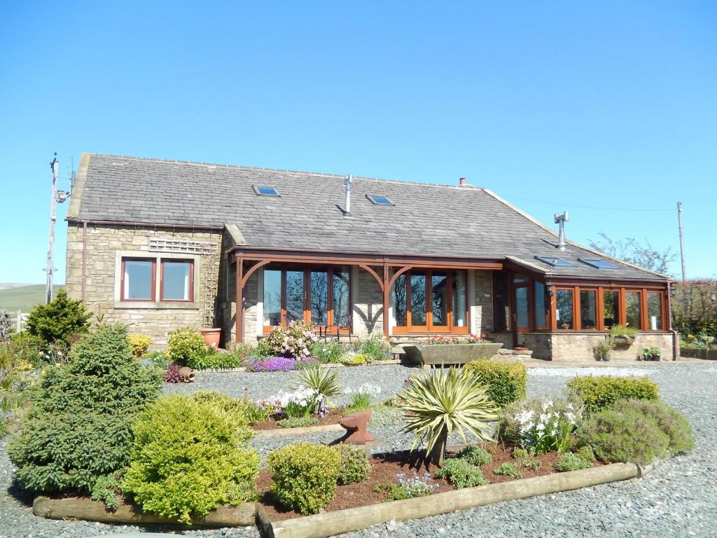 a house with a garden in front of it at Moor View in Ingleton 