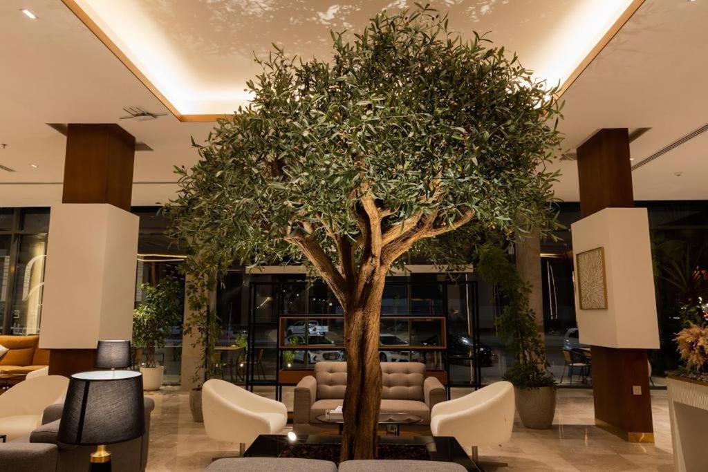 a large tree in the middle of a lobby at ركن تالا للشقق المخدومة in Buraydah