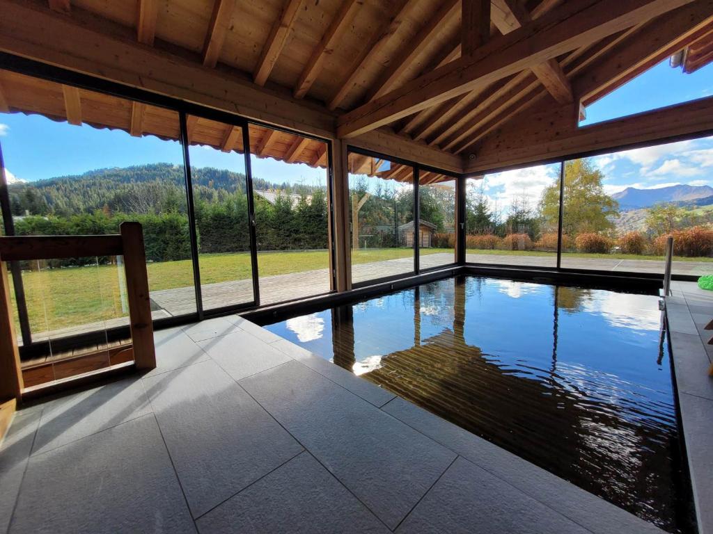 a swimming pool in a house with a view at Chalet Les Gets, 8 pièces, 14 personnes - FR-1-598-27 in Les Gets