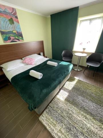 a bedroom with a bed with two pillows on it at Agroturystyka Siekierczyn 249 - Lubań 7 km in Siekierczyn
