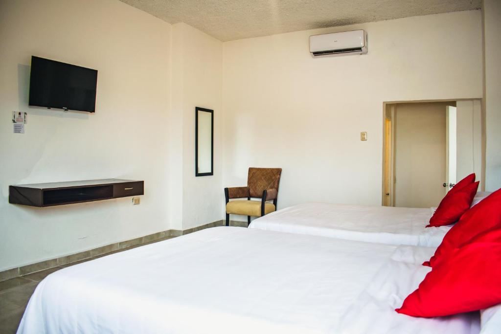 Postel nebo postele na pokoji v ubytování Hotel Cupules