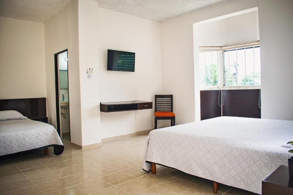 Postel nebo postele na pokoji v ubytování Hotel Cupules