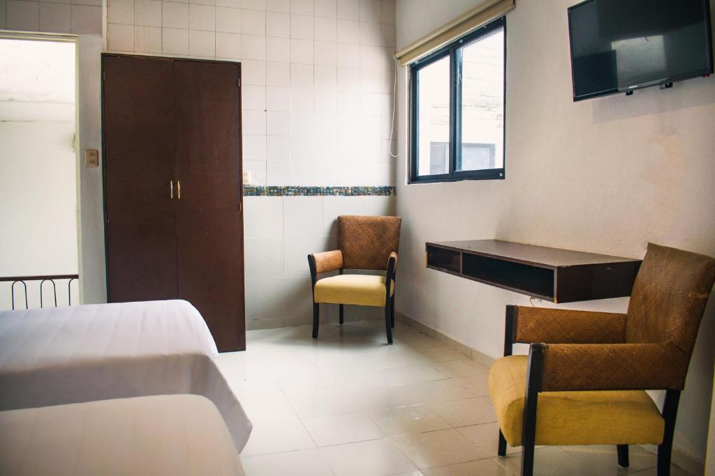 Postel nebo postele na pokoji v ubytování Hotel Cupules