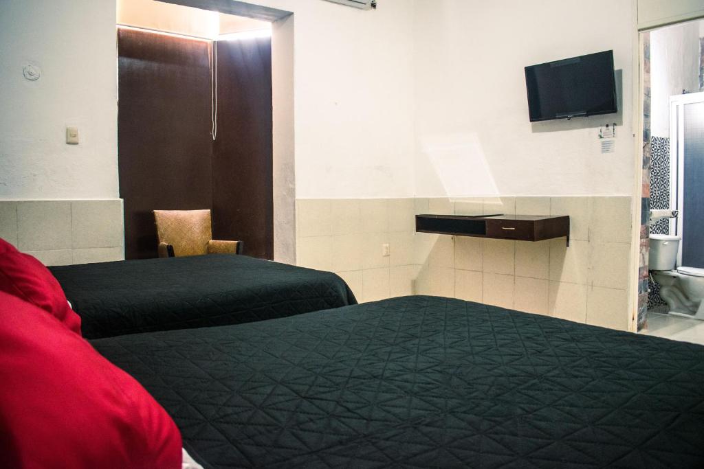 Postel nebo postele na pokoji v ubytování Hotel Cupules