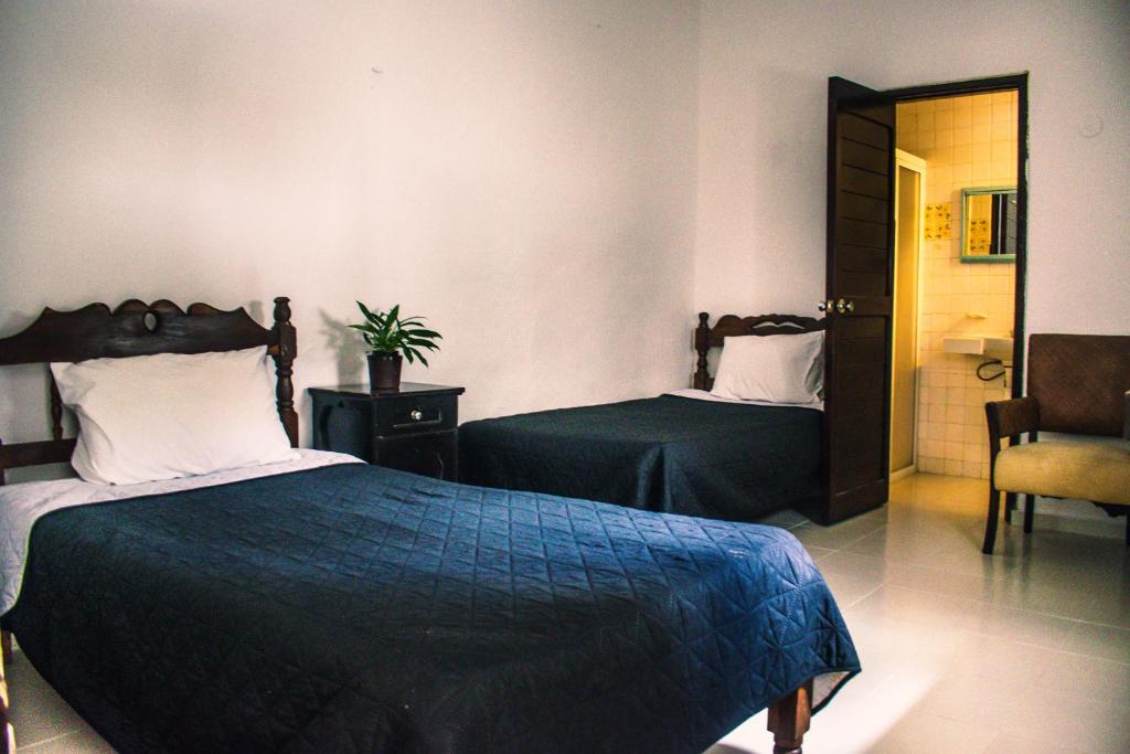 Postel nebo postele na pokoji v ubytování Hotel Cupules