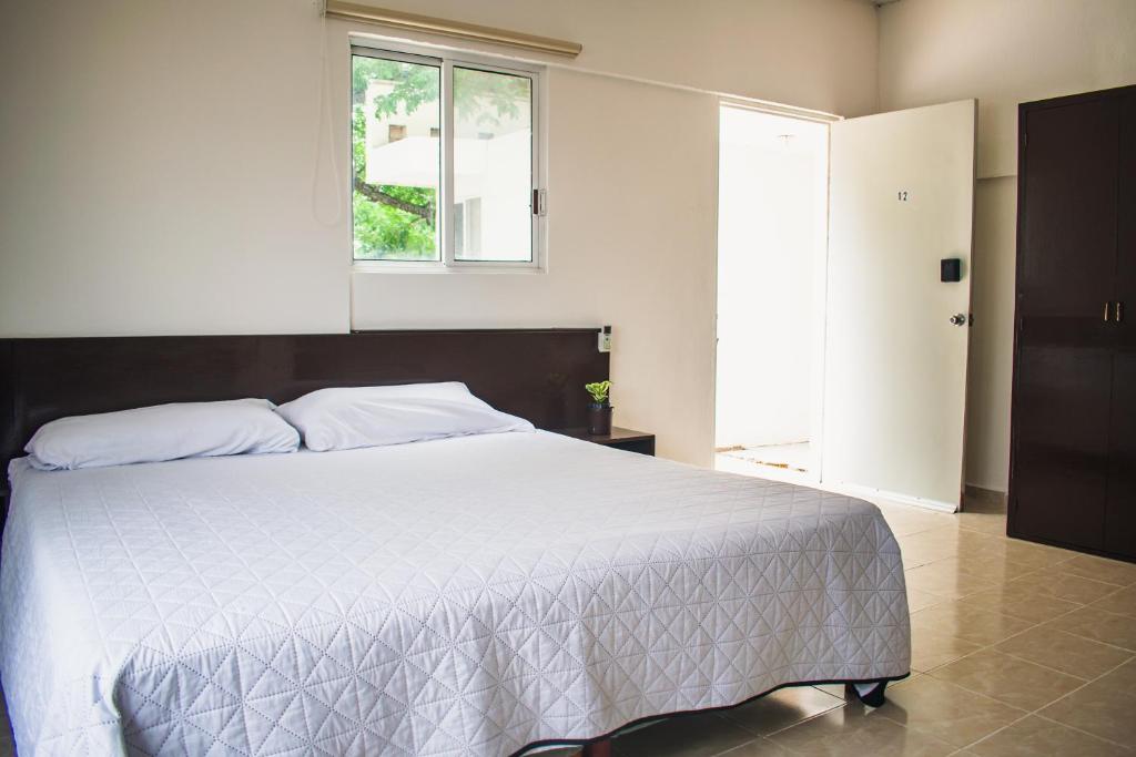 Postel nebo postele na pokoji v ubytování Hotel Cupules