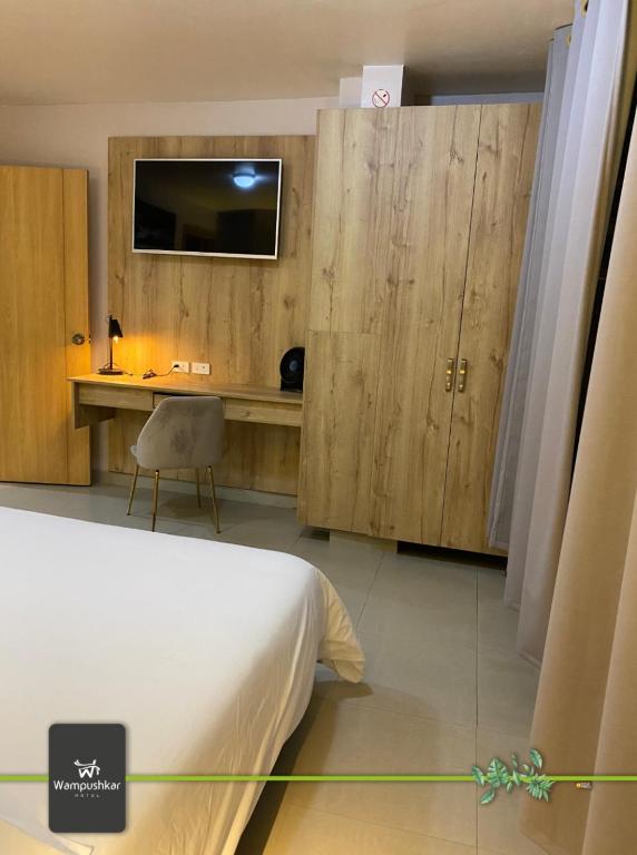 Postel nebo postele na pokoji v ubytování Hotel Wampushkar