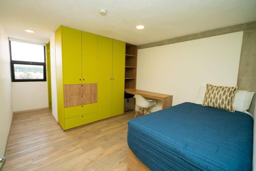 a bedroom with a blue bed and a yellow cabinet at +MS +Loft Coworking +Vigilancia 24hrs +Internet 504 in Laborcillas