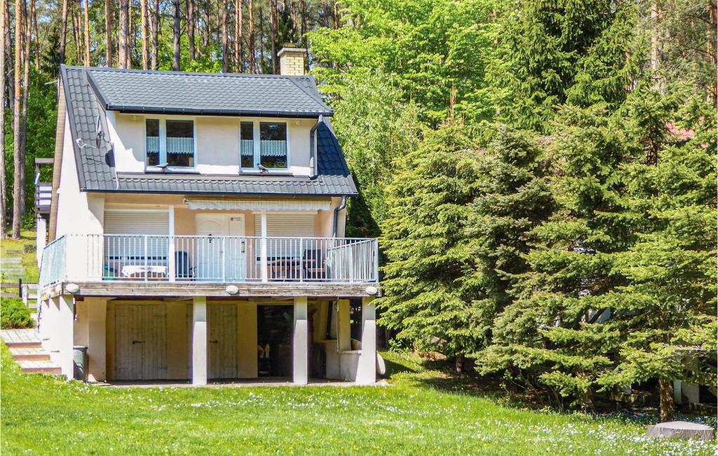 a house with a balcony on the side of it at One-Bedroom Holiday Home In Biskupiec in Biskupiec