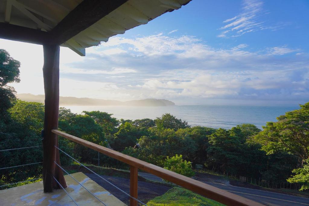 a view of the ocean from the balcony of a house at Venao Surf Lodge in Playa Venao