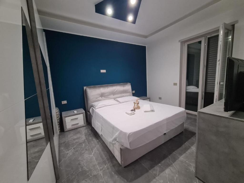 a bedroom with a large bed and a blue wall at il ruggito del leone in Verona
