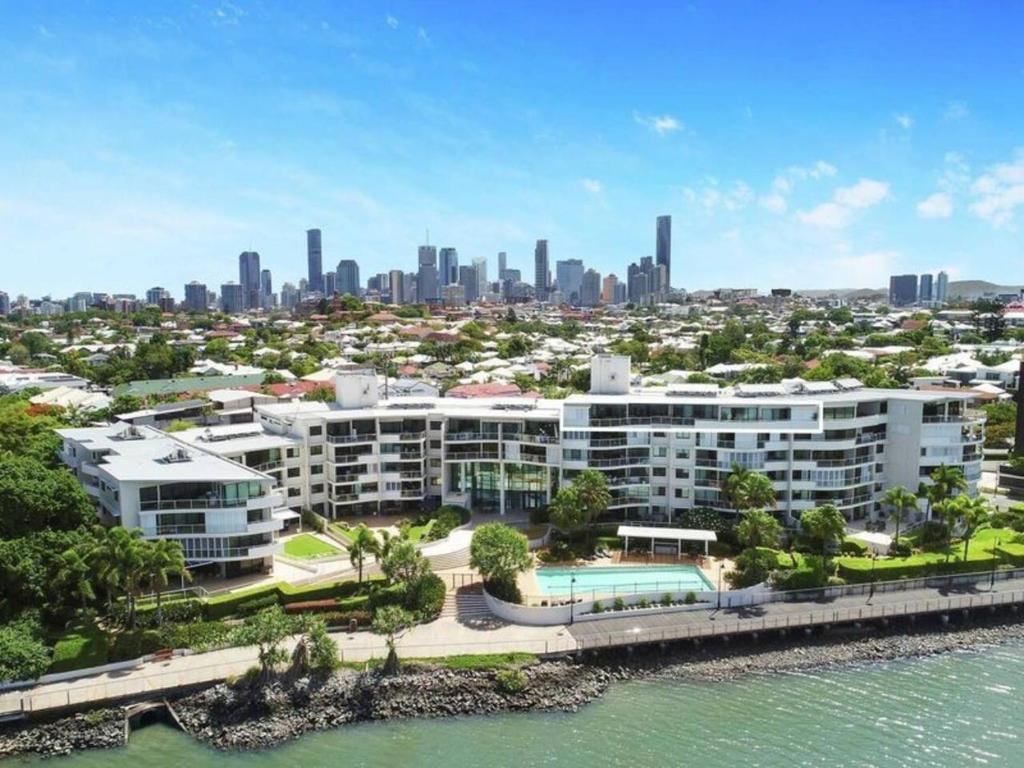 an aerial view of the city and the water at Stylish Riverside Retreat - New Farm in Brisbane