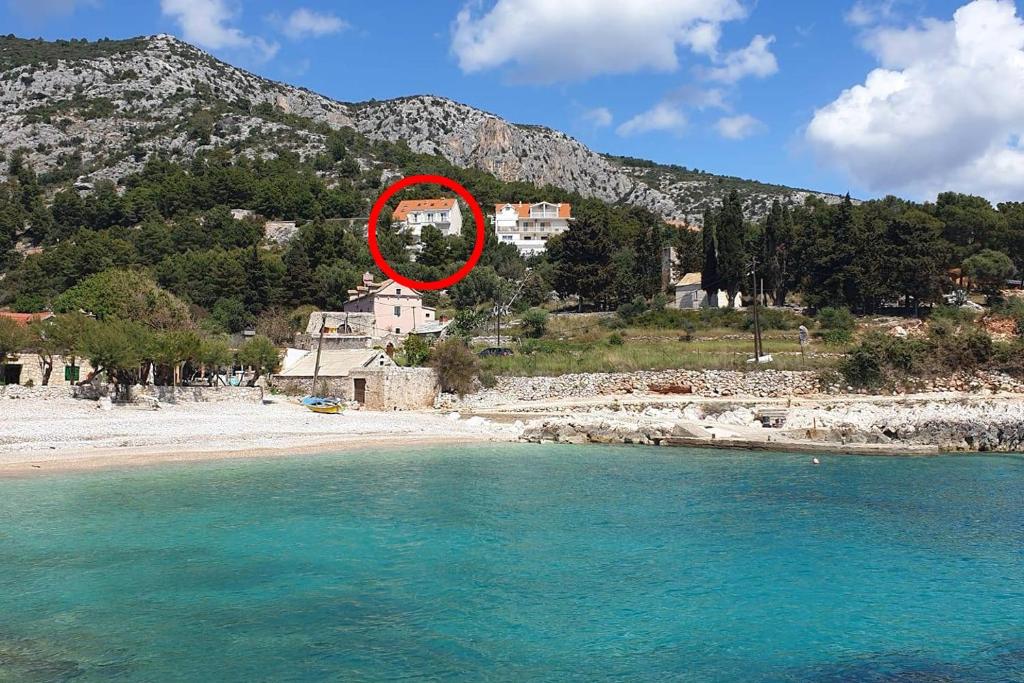 a red circle on a beach near the water at Apartments with a parking space Milna, Hvar - 19850 in Hvar