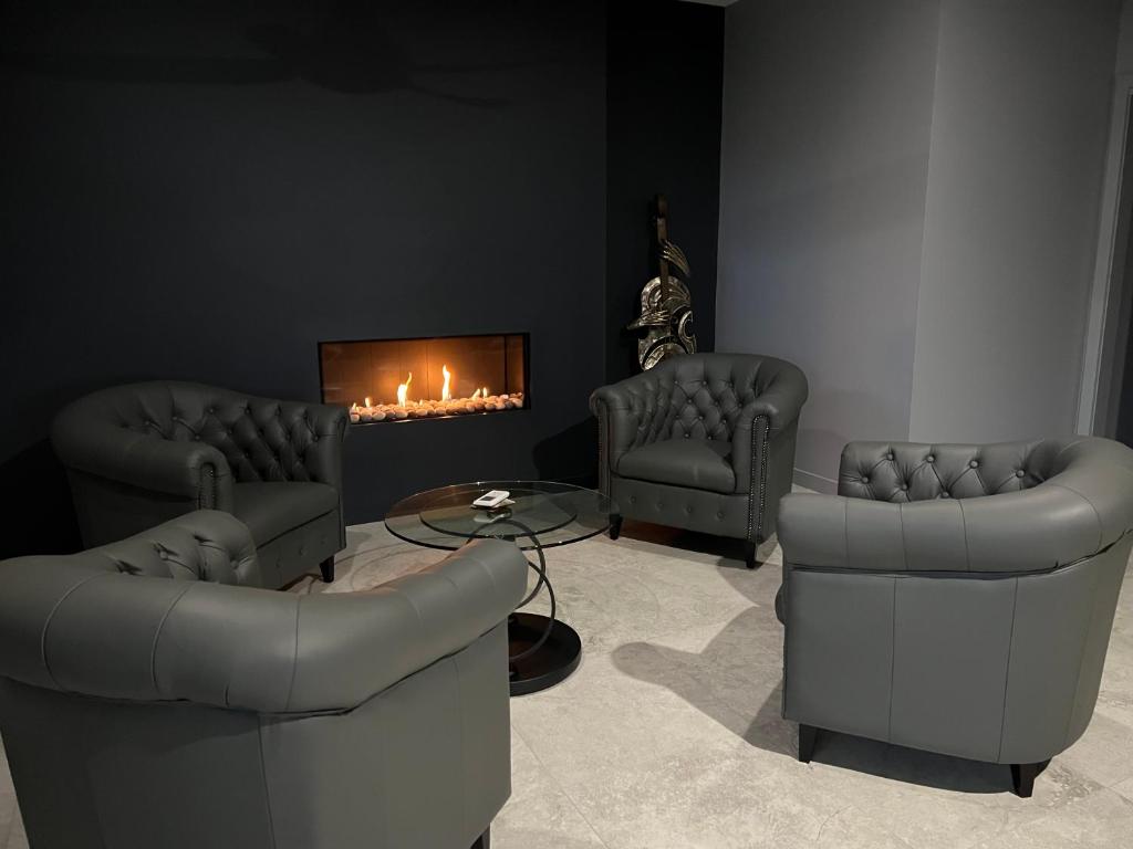a living room with two chairs and a fireplace at 145 Western Adults ONLY in Montville