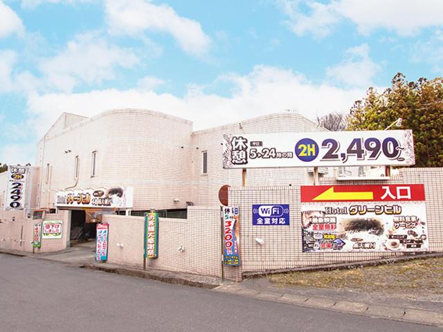 a white building with signs on the side of it at グリーンヒル　大人専用 in Yoshioka