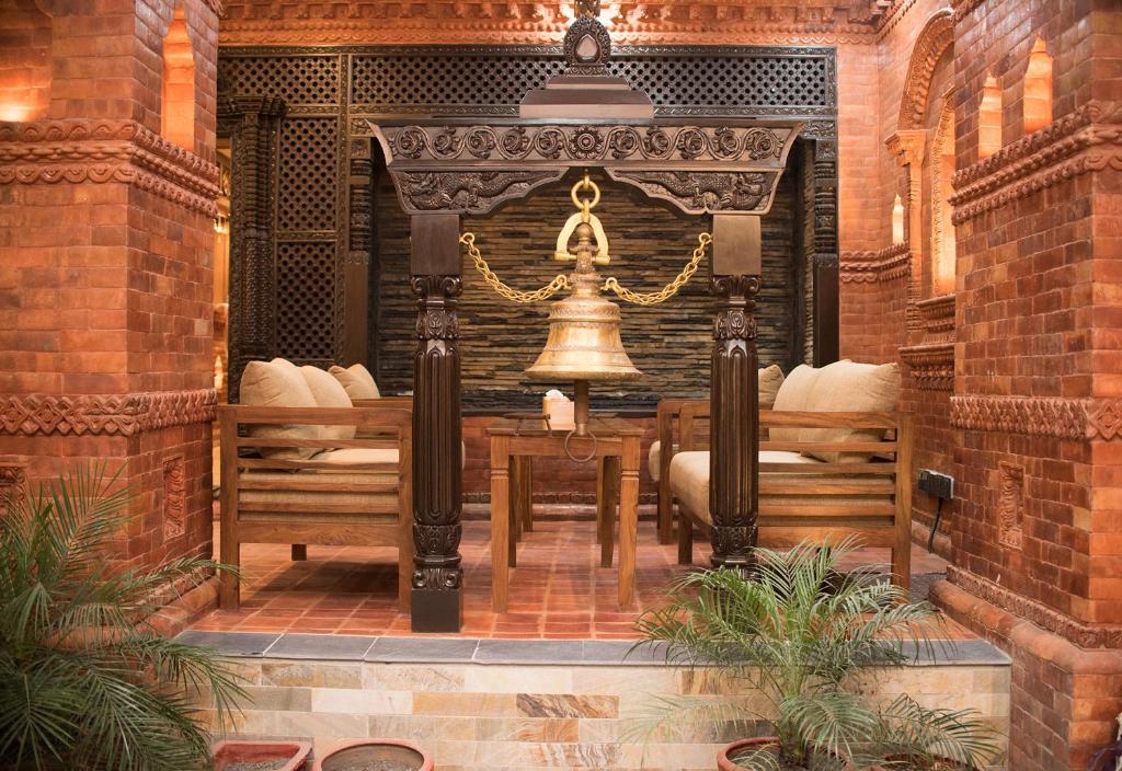 a church with benches and a bell in a building at Everest Boutique Hotel in Kathmandu