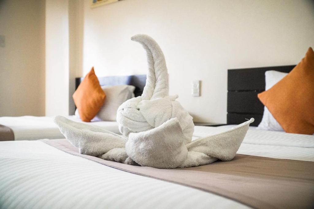 Postel nebo postele na pokoji v ubytování Navarro Hotel