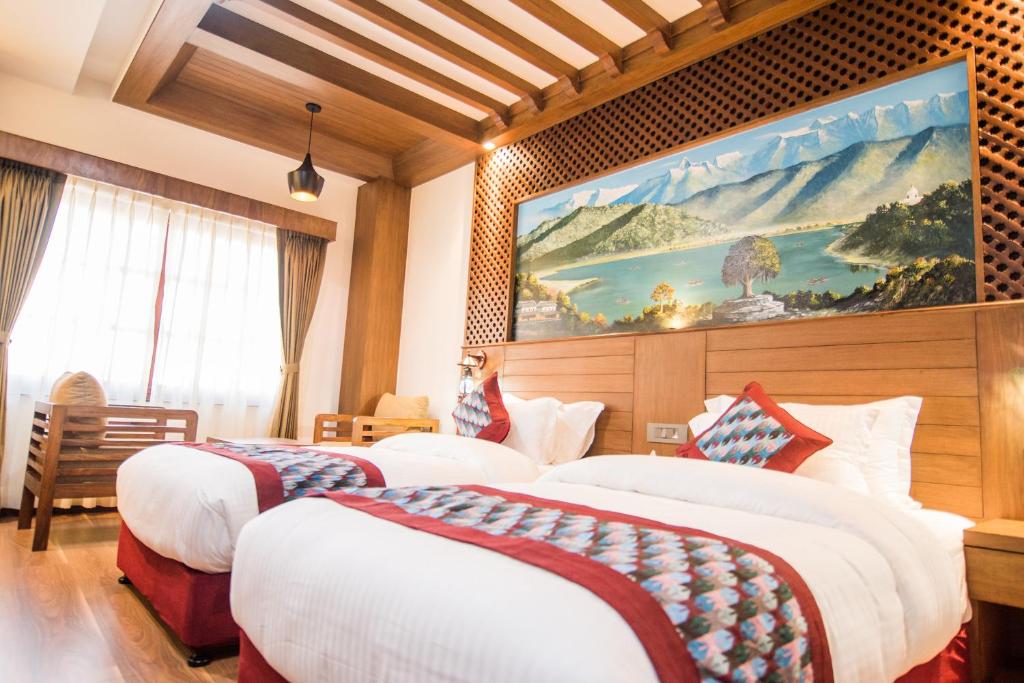 a hotel room with two beds and a painting on the wall at Everest Boutique Hotel in Kathmandu