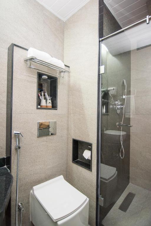 a bathroom with a toilet and a glass shower at Everest Boutique Hotel in Kathmandu