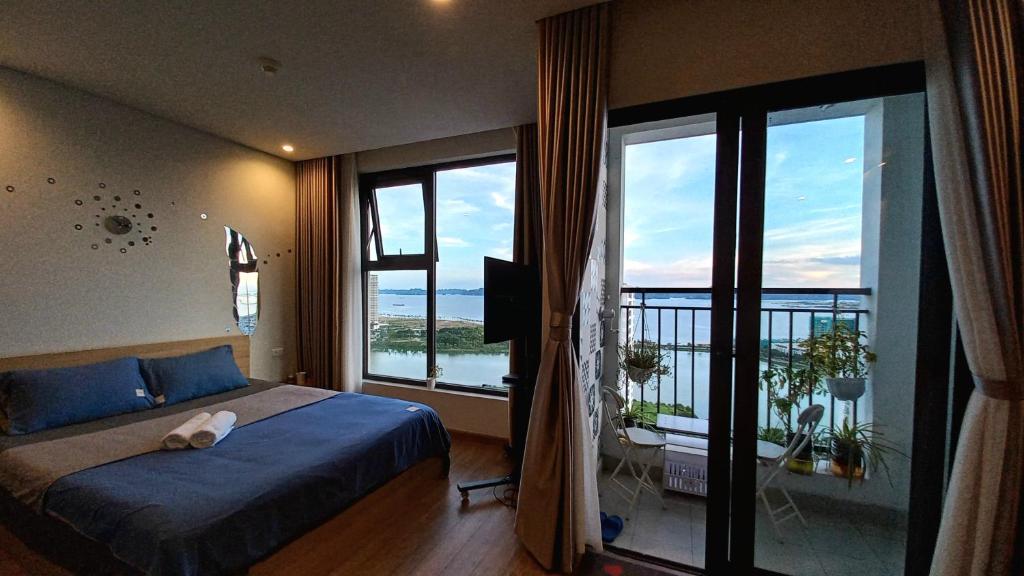 a bedroom with a bed and a large window at Ha Long Bay View Studio in Ha Long