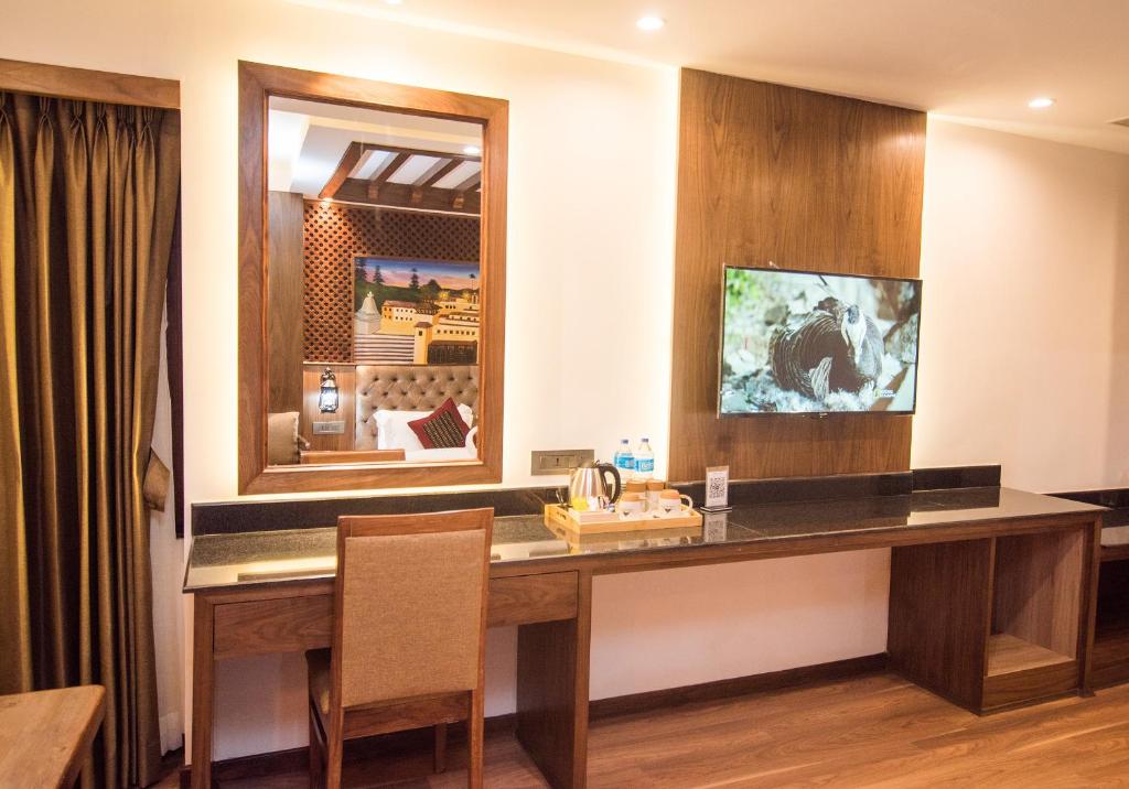 a desk in a room with a mirror at Everest Boutique Hotel in Kathmandu