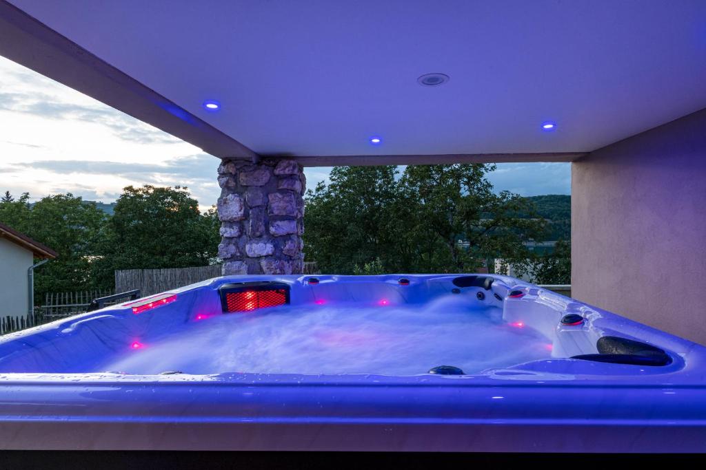 a large blue bath tub on a patio with a fireplace at Nidam in Bilieu