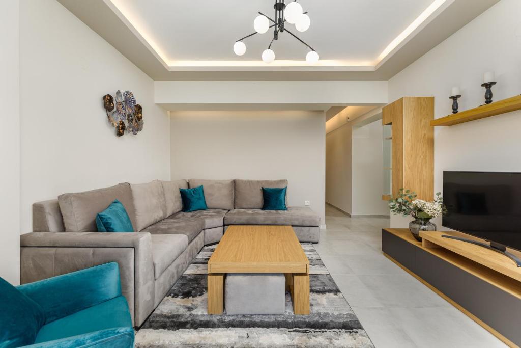 a living room with a couch and a table at Central Luxury Apartment in Thessaloniki