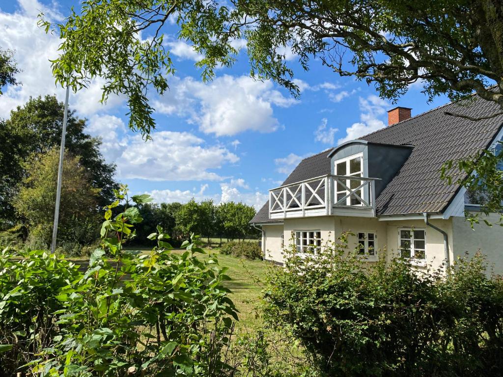 a white house with a black roof at Sunbjerre B&B in Lille Dalby