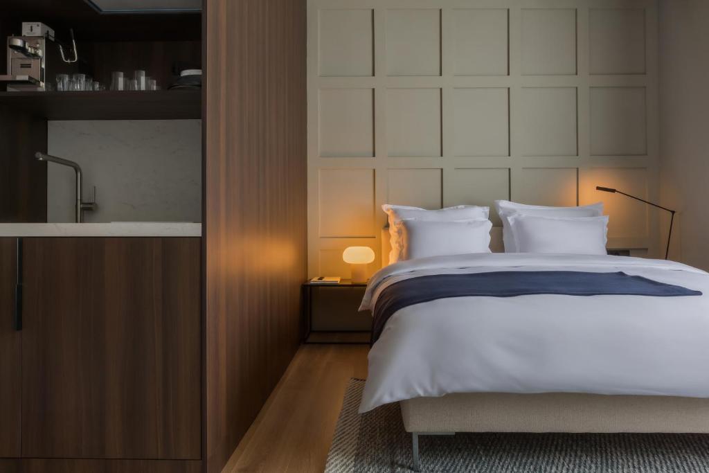 a bedroom with a large bed with white pillows at Bona Fide Main Square Designer Apartments in Zagreb