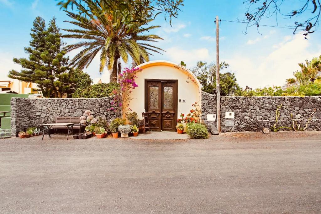 een huis met een stenen muur en een houten deur bij Casa Verde in Teguise