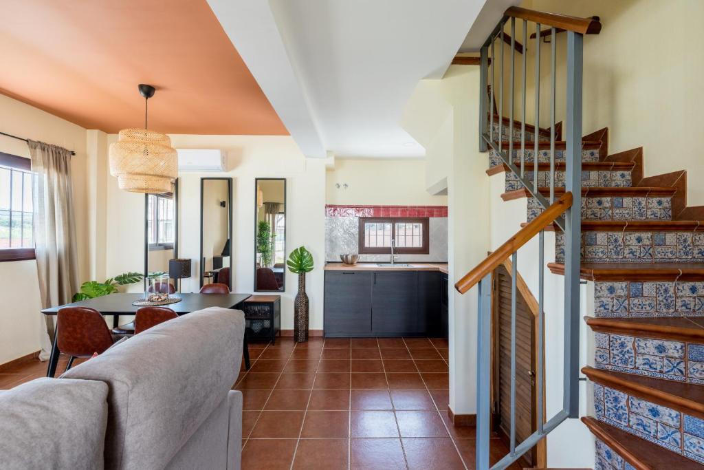 a living room with a staircase and a living room at Casa Rural Sierramagna de 1 Dormitorio in El Ronquillo
