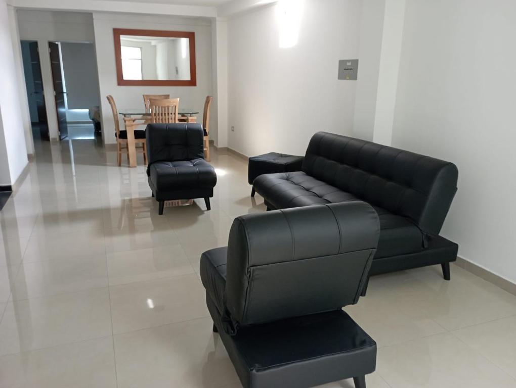 sala de estar con sofá, sillas y mesa en Apartamentos Claudia María, en Barbosa