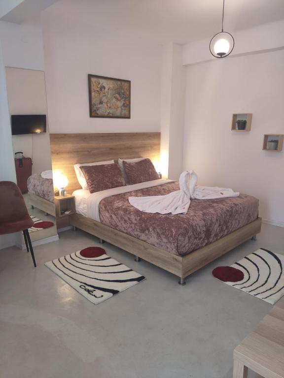 a bedroom with a large bed and a table at Sweet home in Chanioporta in Heraklio Town