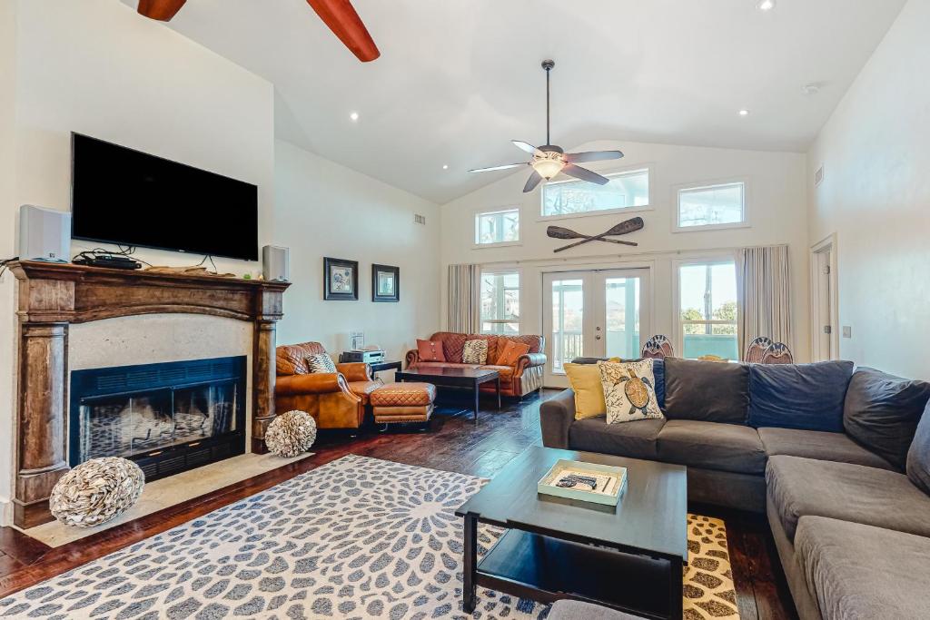 a living room with a fireplace and a tv at Sunsets At Joe's in St. George Island