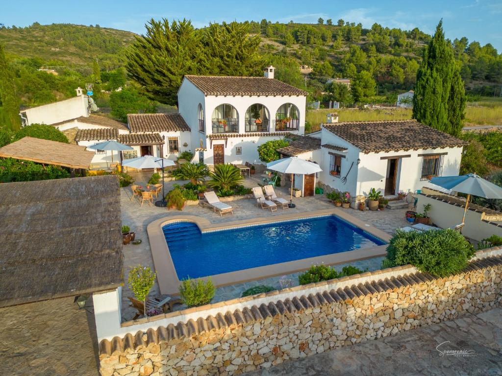 an aerial view of a house with a swimming pool at Casa Llibertat boutique stay with spa in Lliber