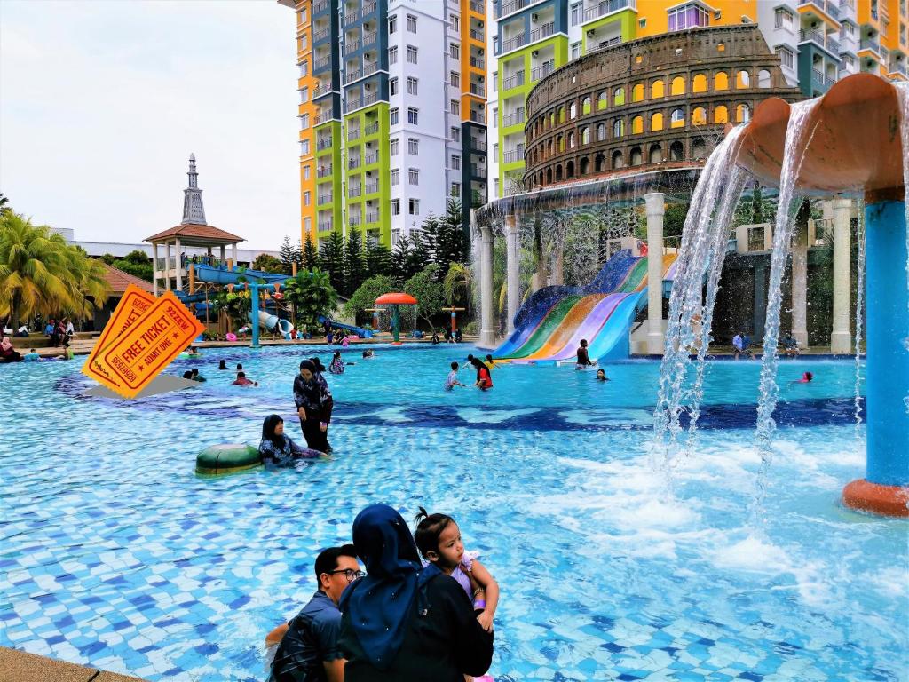 a group of people sitting in a water park at FHS Water Themepark Resort Melaka Town City Tengah in Melaka
