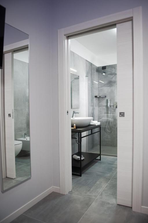 a bathroom with a sink and a mirror at B&B Lough in Colà di Lazise
