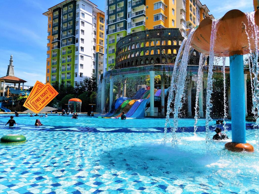 a pool with a water park with people in it at HomeStay at Melaka # Free WiFi # Water ThemePark Tickets in Malacca