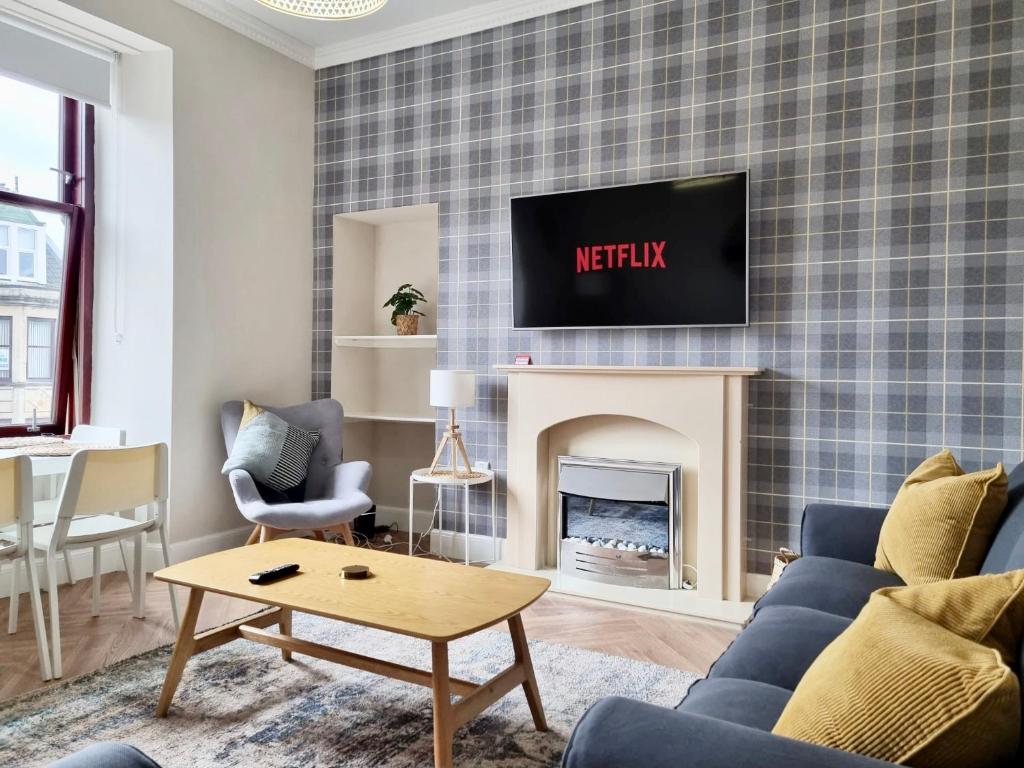 a living room with a tv above a fireplace at The Haven in Greenock