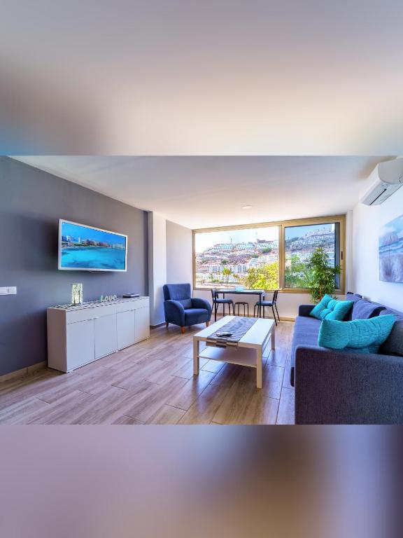 a living room with a couch and a table at La Cascada 202 in Puerto Rico de Gran Canaria