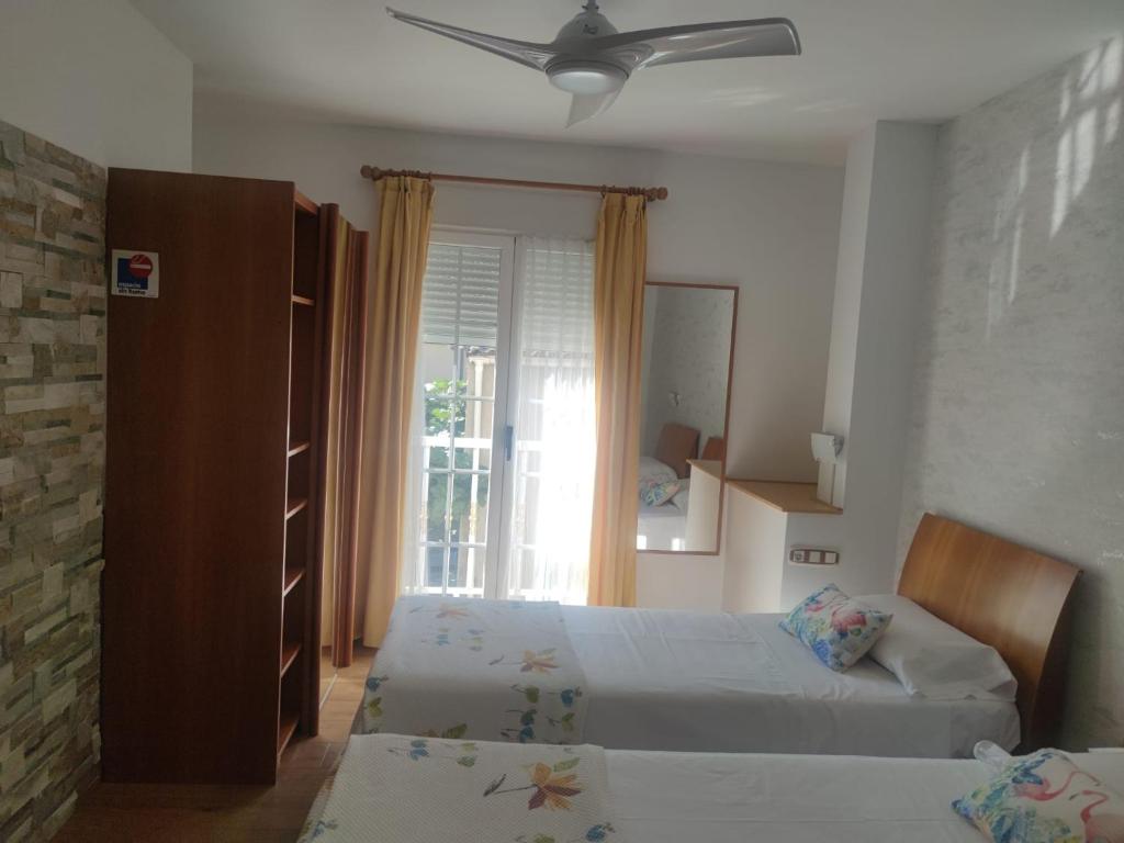 A bed or beds in a room at Hostal Burbia