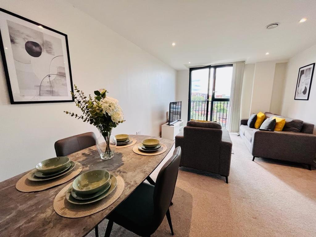a living room with a dining room table with chairs at Modern 1 Bedroom Apartment by BOLD Apartments in Liverpool
